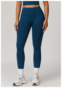 Detail view of high-waisted teal yoga pants with seamless ribbed waistband and athletic knit