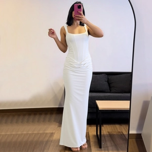 Detailed view of white sleeveless maxi dress with corset waist and elegant ruching details
