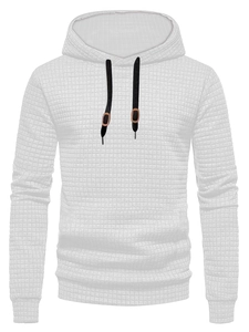 Detail shot of men's white waffle textured fabric with black drawstrings and brown patches