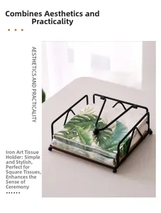Detail of black iron napkin holder with wood base and weighted arm for square tissues