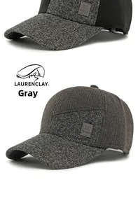 Detail einer grauen Winter-Baseballkappe mit Tweed-Stoff und Leder-Logo-Patch-Applikation