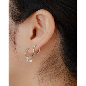 Close-up of S925 sterling silver hoop earrings with three sparkling zircon charms