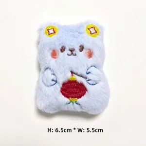 Detail of blue plush bear accessory with traditional Chinese embroidery, 6.5cm x 5.5cm size