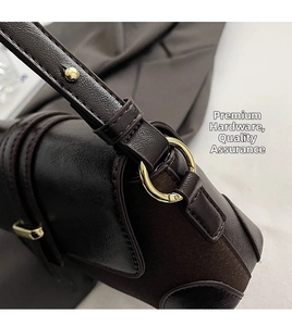 Close-up of golden hardware and premium textured leather on a dark brown vintage bag