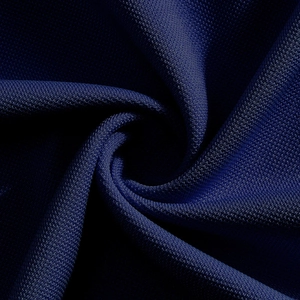 Detail of navy blue breathable knit fabric showing moisture-wicking synthetic texture