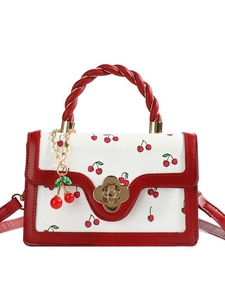Sweet cherry print crossbody bag with red woven handle and clover-shaped twist lock