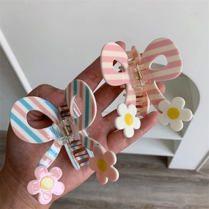 Sweet butterfly hair claw clips with floral accent in blue and pink striped patterns
