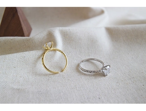 Detail of minimalist open rings with square cut stones in gold and silver finishes