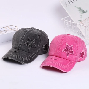 Detail of distressed baseball caps with sequin stars and vintage frayed edges