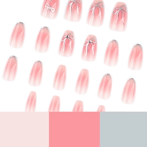 Pink blush gradient press-on nails with silver bow charms and french style design