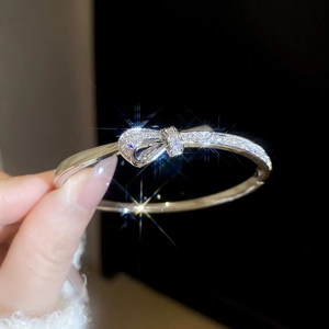 Macro shot of silver bow bracelet with pave-set sparkling cubic zirconia crystals