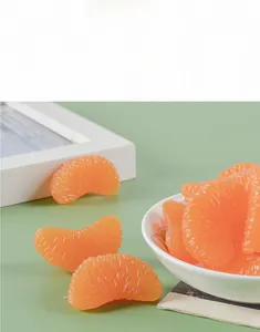Macro detail of realistic orange segment fruit slices with vivid pulp texture on green surface