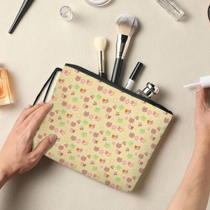 Cute cartoon bear makeup bag with zipper and wrist strap showing brushes and lipstick