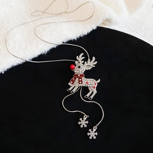 Macro detail of silver reindeer necklace pendant with crystal rhinestones and snowflakes