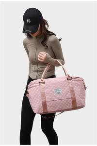 Pink quilted nylon gym bag with reinforced handles and adjustable shoulder strap for travel