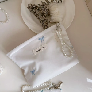 Blue bow embroidered white satin mini bag with pearl chain handle and simple wish label