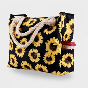 Detail view of sunflower tote bag with rope handles and side pocket for a cup