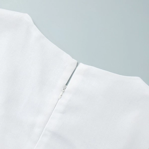 Detail of high-quality invisible zipper on a white square neck cotton linen maxi dress