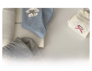 Detail of cute puppy embroidery and plaid bow on ruffled edge cotton crew socks