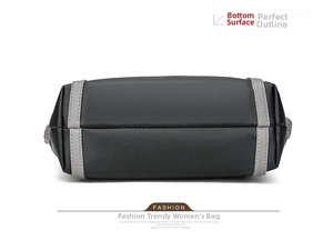 Detail view showing bottom construction and stitching of black soft leather tote bag