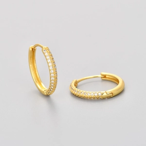 Detailed macro shot of micro-pave hoop earrings with sparkling cubic zirconia inlay
