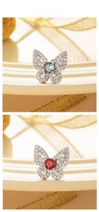 Detail of silver butterfly earrings with sparkling crystals and colorful center stones