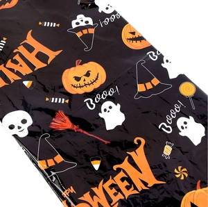 Detail of Halloween plastic tablecloth with orange pumpkins and white ghosts pattern