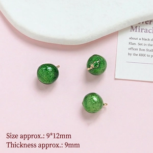 Detail showing green sphere pendants with gold clips and mini leaf charm 9x12mm