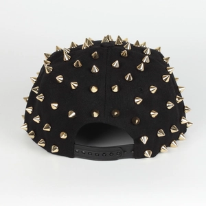 Adjustable black snapback strap on a punk style hip-hop hat with gold cone studs