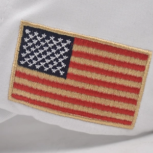 Detailed close-up of high-quality American flag 3D embroidery on a white cotton cap