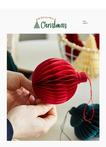 Close-up of red honeycomb paper Christmas ornament with layered 3D folding structure