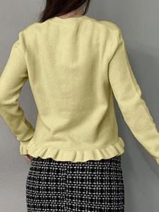 Women's yellow long sleeve knit sweater with ruffled hem design and elegant back view style