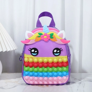 Macro detail of unicorn pop-it backpack showing colorful fidget bubbles and purple finish