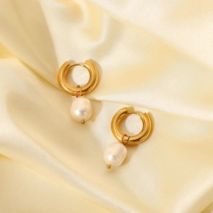 Close-up of gold stainless steel hoop earrings with natural white freshwater pearl drops