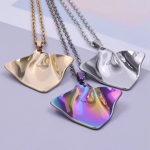 Polished manta ray pendant necklaces in gold, silver, and iridescent hues on chains