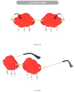 Detail of red cloud-shaped rimless sunglasses with gold frames and hanging lightning charms
