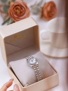 Silver ladies watch with rhinestone bezel and calendar display in a gift box
