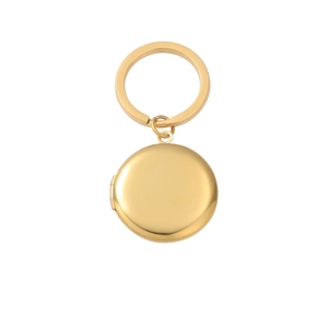 Detailed view of a golden circular locket keychain with hinge for DIY photos