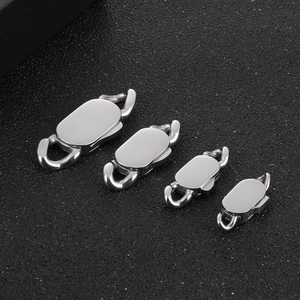 Detailed macro view of four sizes of polished stainless steel oval snap clasps for jewelry