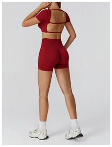 Detail of red seamless yoga set featuring hollow out back straps and high waist shorts