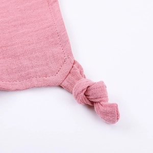 Close-up of pink cotton gauze security blanket corner with a soft knot detail