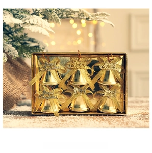 Close-up of golden Christmas bells set with glittery bows and Merry Christmas tags