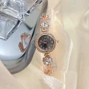 Detail of rose gold quartz watch with rhinestone floral strap and numeric black dial