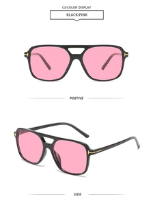 Detail of classic square sunglasses with gold T-shaped accent and pink lenses