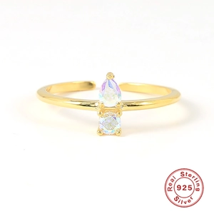 Detail of 925 sterling silver gold ring with pear shaped iridescent opal stones