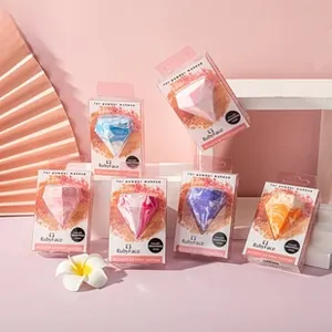 Macro detail of diamond-shaped marble makeup sponges in individual gift boxes