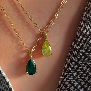 Gold box chain necklaces featuring emerald and peridot waterdrop zircon pendants on a model