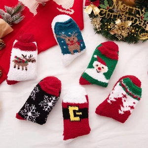 Flat lay of warm coral fleece Christmas socks featuring festive patterns and soft texture