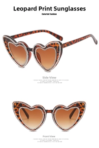 Macro view of leopard print heart-shaped sunglasses with sparkling rhinestone edges