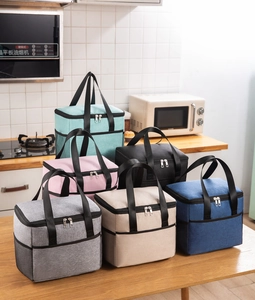 Detailed view of insulated lunch bags in six colors arranged on a wooden kitchen counter